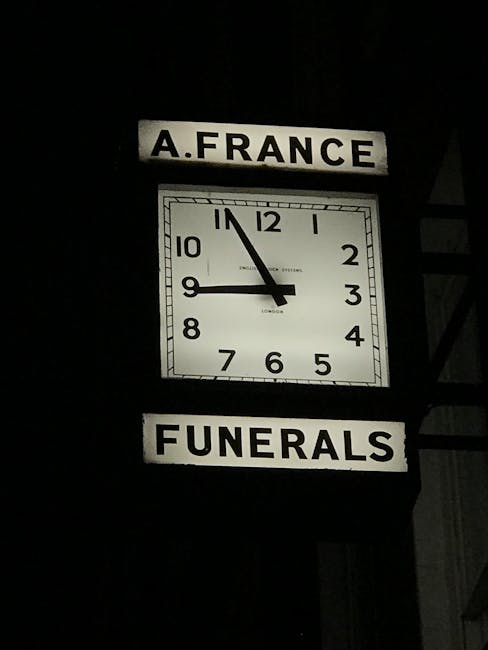 No flowers or floral arrangements are visible in this image. Instead, the image features a white square clock displaying approximately 11:52, mounted on a dark background. Above the clock is a rectang